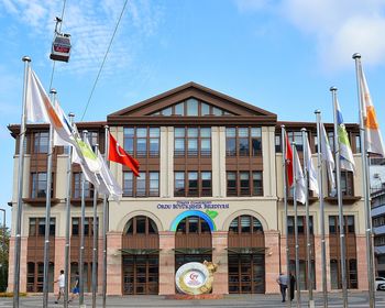 Low angle view of flag against buildings in city