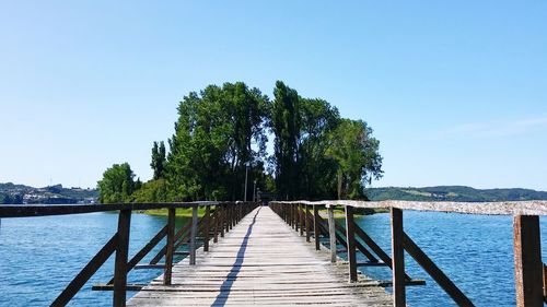 Scenic view of pier against clear blue sky