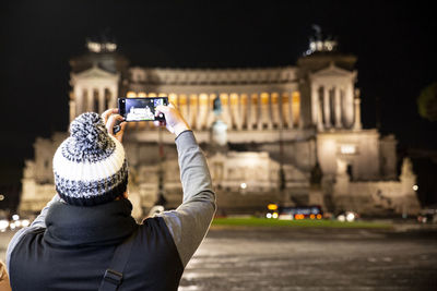 Rear view of person photographing