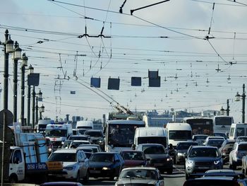 Traffic on road in city against sky