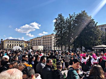 People on street against sky