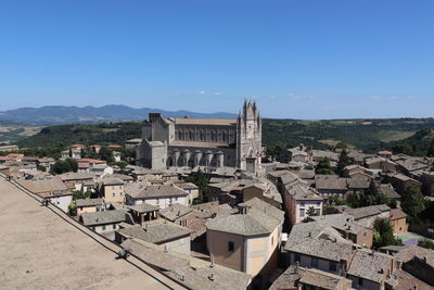 Buildings in town against clear sky