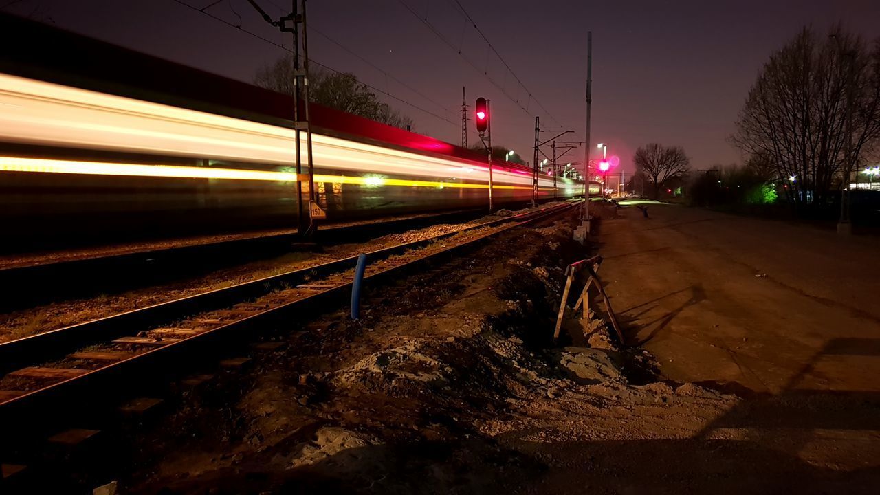 TRAIN ON RAILROAD TRACK AT NIGHT
