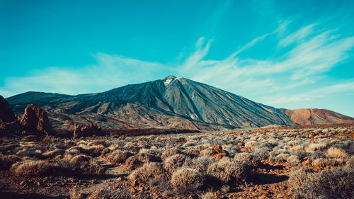 Scenic view of volcanic mountain against sky