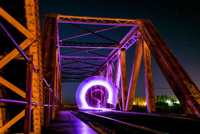 Lightpainting on train bridge at night