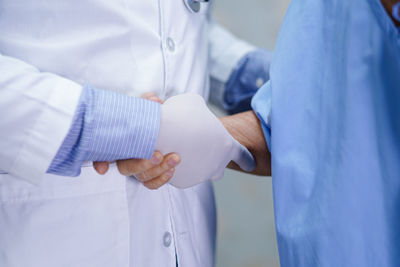 Midsection of man holding hands