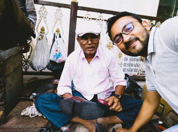 Portrait of friends sitting outdoors