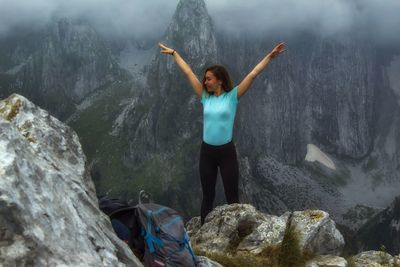 Girl standing on rock at mountain