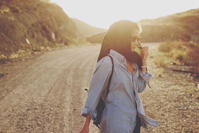 Woman standing on road