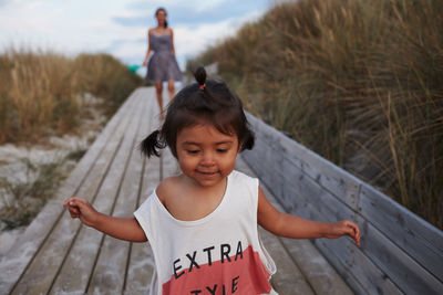 Smiling girl on boardwalk