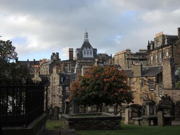 Buildings against cloudy sky