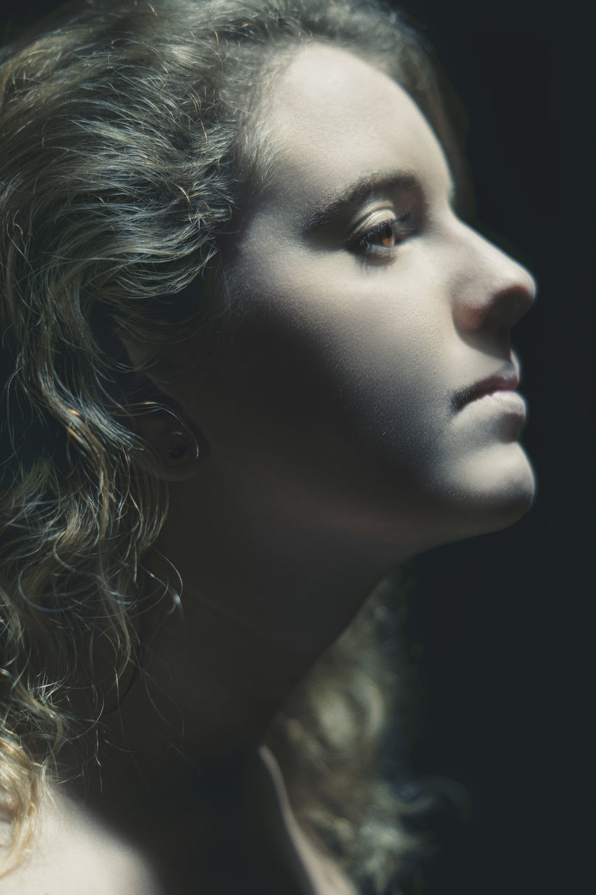 close-up, headshot, indoors, looking, young adult, portrait, looking away, one person, young women, human body part, body part, real people, studio shot, women, hair, lifestyles, leisure activity, beauty, contemplation, hairstyle, human face, beautiful woman, black background