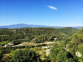 Scenic view of landscape against blue sky