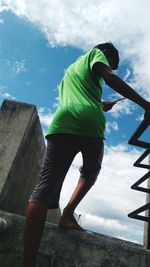 Low angle view of man standing against sky