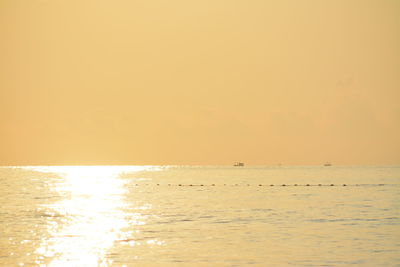 Scenic view of sea against orange sky