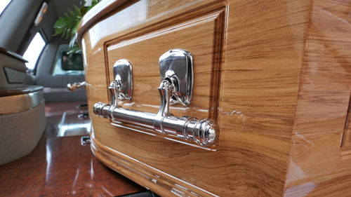 Close-up of faucet on wooden table