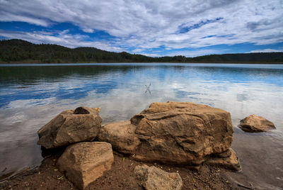 Scenic view of rocks in lake against sky