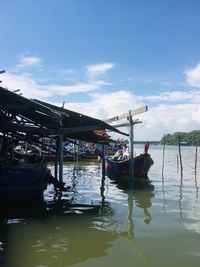 Boat moored in lake against sky