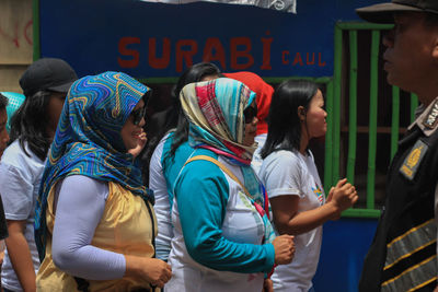 Group of people in traditional clothing standing outdoors