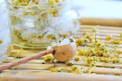 Close-up of sugar in wooden spoon on table