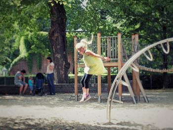 Side view of man sitting in park