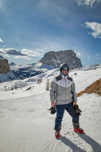 Skiers with ski suits at the grohmannspitze in the dolomites are looking at the camera with a smile