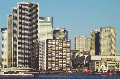 Urban skyline against clear sky