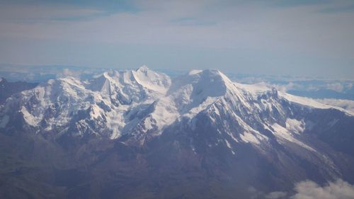 Scenic view of mountains against cloudy sky