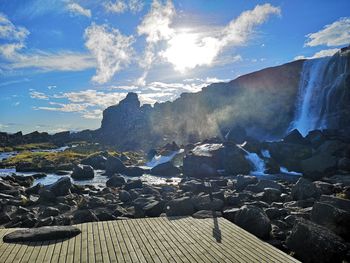 Scenic view of waterfall against sky