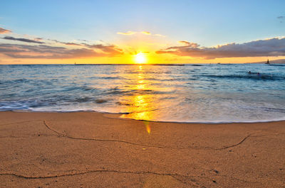Sunset on world famous waikiki beach on oahu, hawaii. 