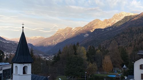 Panoramic view of buildings and mountains against sky