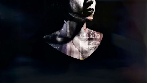 Digital composite image of man with reflection against black background