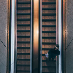 Directly above shot of man on escalator in building