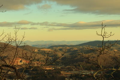 Scenic view of mountains against sky at sunset