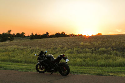 Scenic view of a field on a hill during a kansas sunset