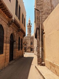View of alley amidst buildings in city