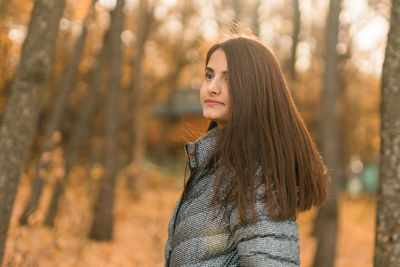Young woman standing in forest