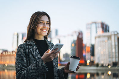 Portrait of young woman using mobile phone