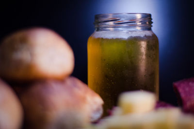 Close-up of beer in jar with bread and cheese