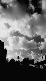 Low angle view of building against cloudy sky