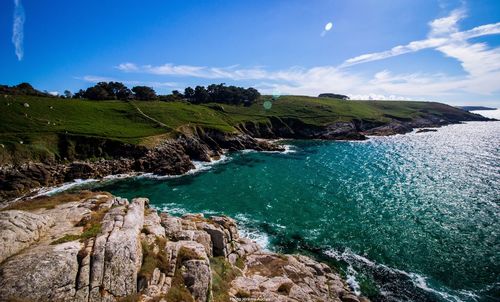 Scenic view of sea against blue sky