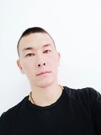 Portrait of young man against white background