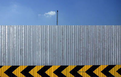 Close-up of text on metal against sky