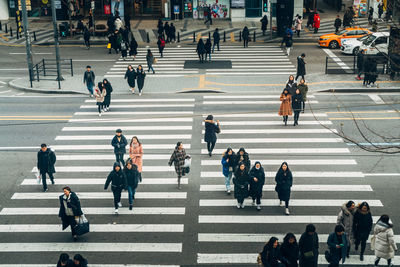 High angle view of people crossing road in city