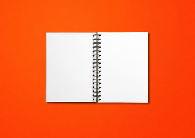 Close-up of open book against orange background