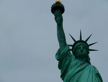Low angle view of statue of liberty against sky