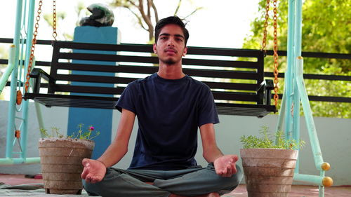 Portrait of young man sitting outdoors