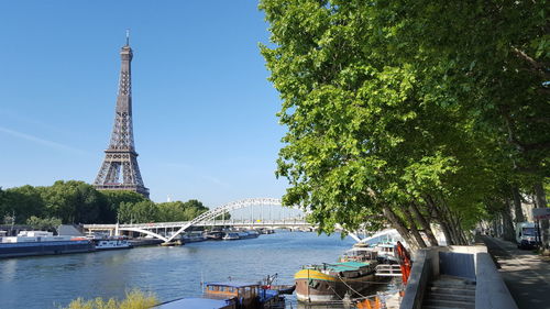 View of boats in river with city in background