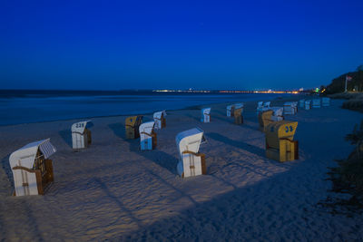 Scenic view of beach against clear blue sky