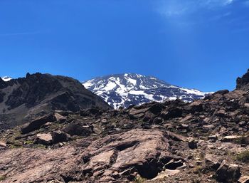 Scenic view of snowcapped mountains against clear blue sky